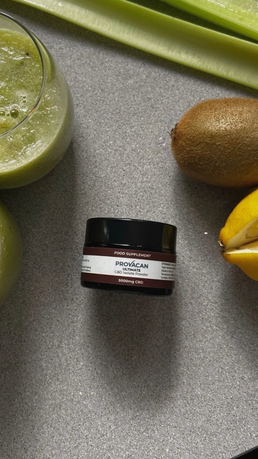 Provacan Ultimate CBD Isolate Powder 5000mg CBD on grey countertop next to smoothie and fruits