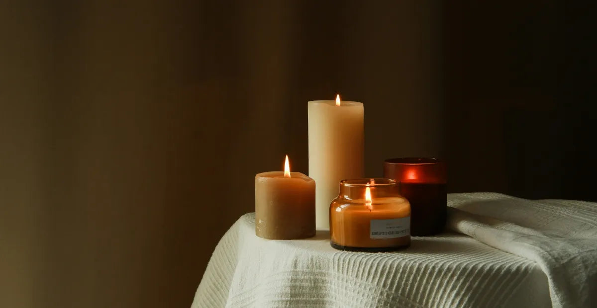 Provacan Natural Stress Relief: Four candles on a table with white cloth