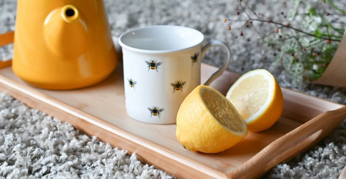 Provacan Natural Stress Relief: Tea kettle next to tea cup and lemon cut in half on a wooden tray