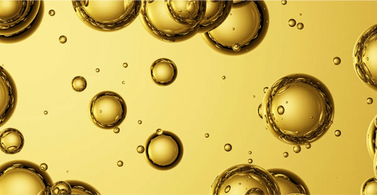 Close-up of gold CBD oil with bubbles