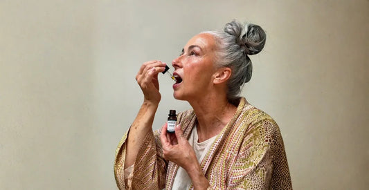 Woman holding a dropper of Provacan Complete 600mg 6% CBD oil