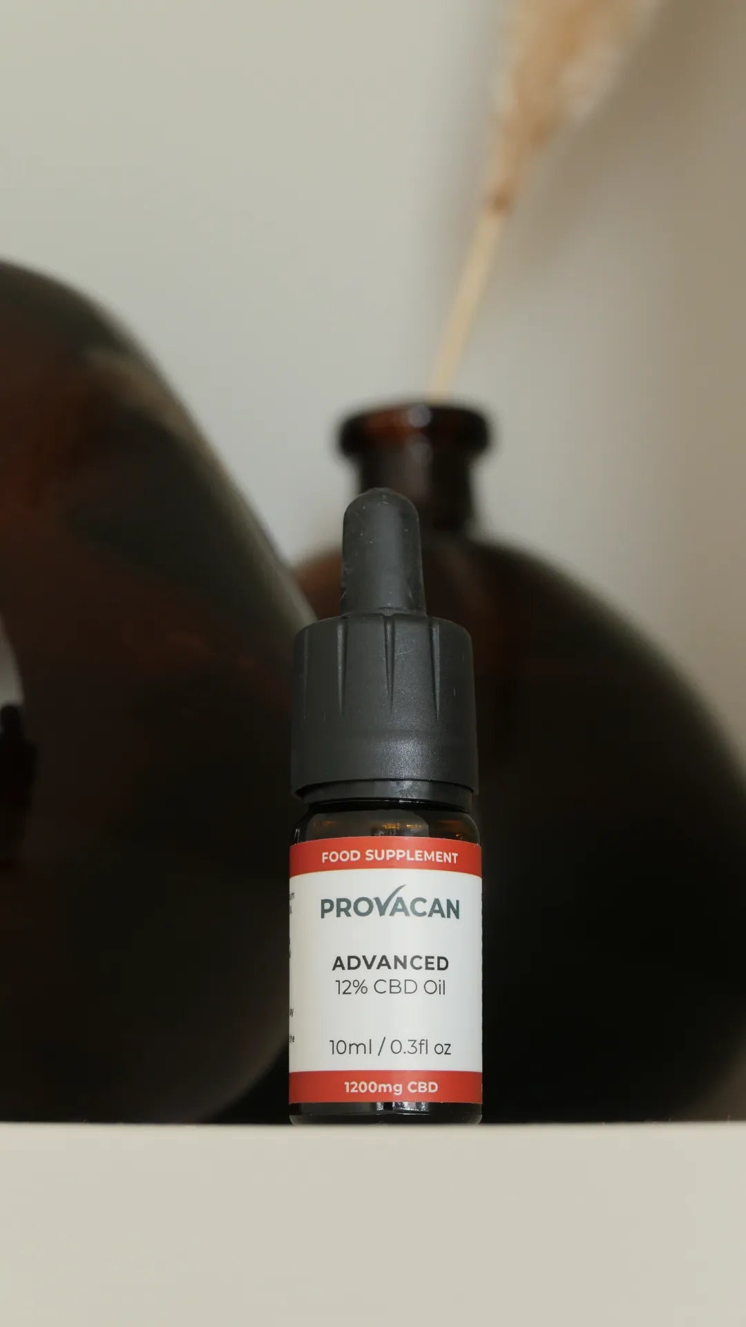 Bottle of Provacan CBD oil with a blurred background