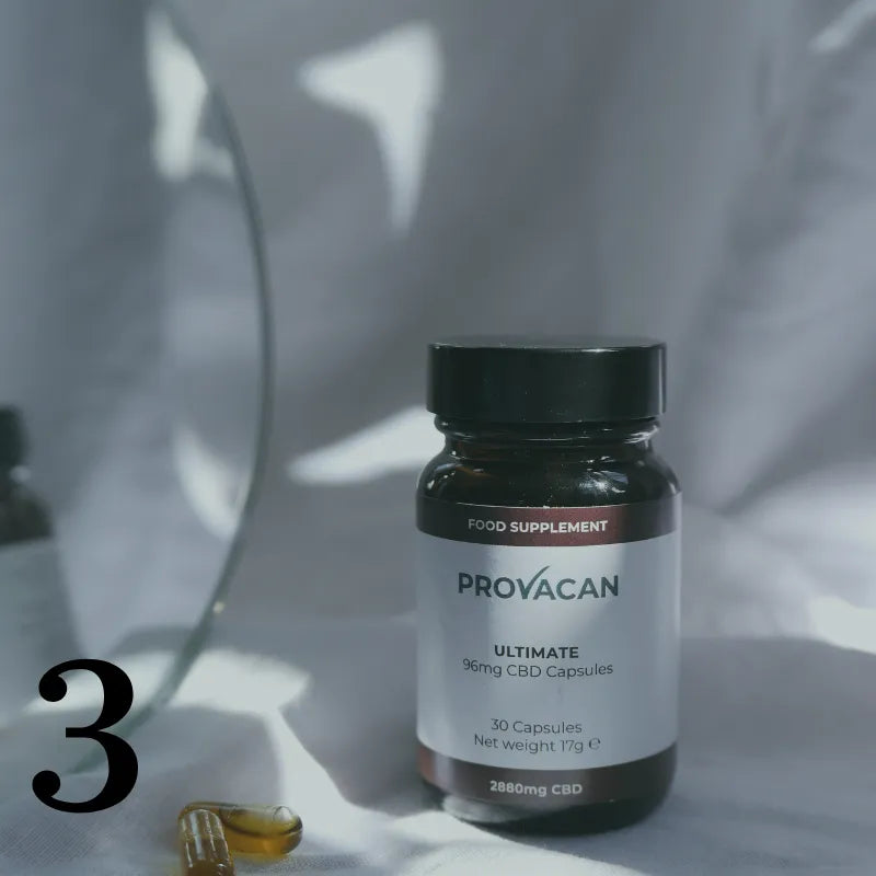 Jar of Provacan 96mg CBD Capsules with two capsules on the side, amidst bedsheets. Number 3 written in bottom left corner.