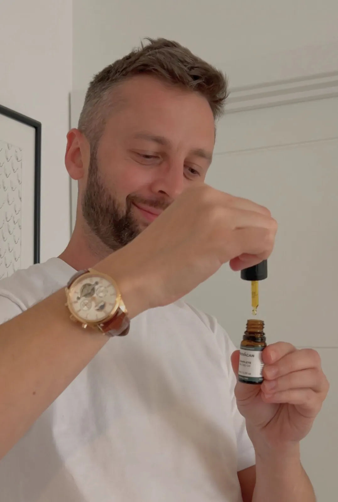 Man holding a dropper of Provacan Complete 600mg CBD oil