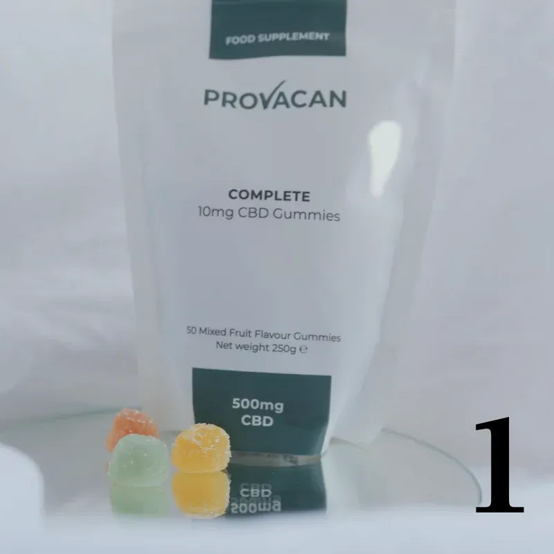 Pack of Provacan 10mg CBD Gummies with three colourful gummies in front, amidst bedsheets. Number 1 written in bottom right corner.