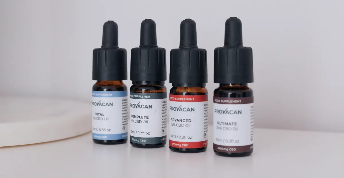 Close-up of CBD oil from Provacan: Vital 300mg CBD oil, Complete 600mg CBD oil, Advanced 1200mg CBD oil, Ultimate 2400mg CBD oil on a white desk