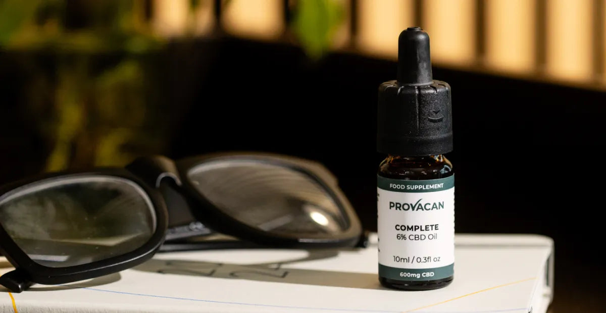 Provacan Complete CBD oil 6% 600mg on a notebook with sunglasses