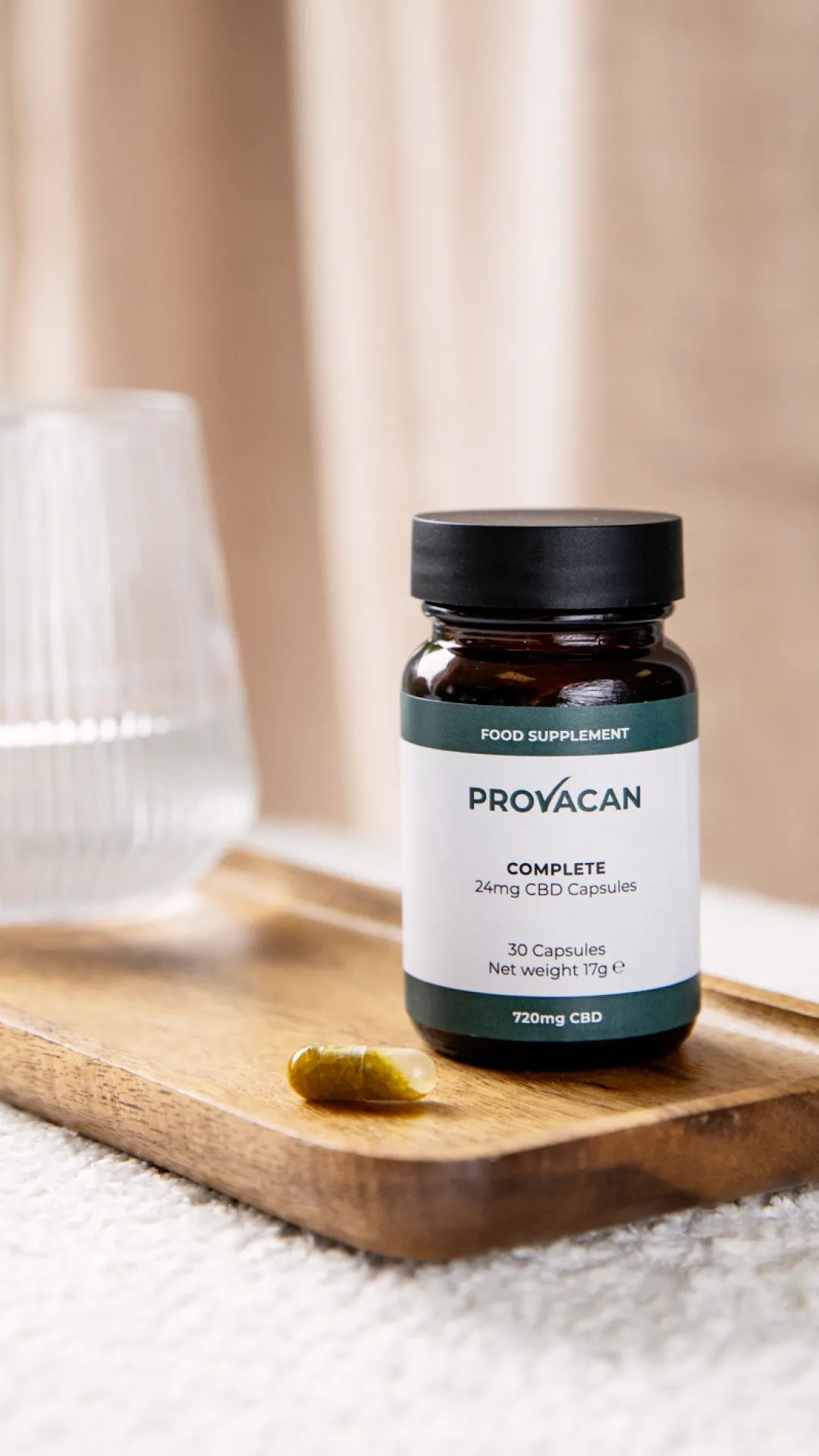 Bottle of Provacan Complete CBD Capsules supplement 24mg on a wooden tray