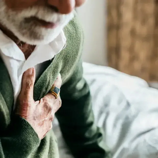 Close-up of a man holding his chest