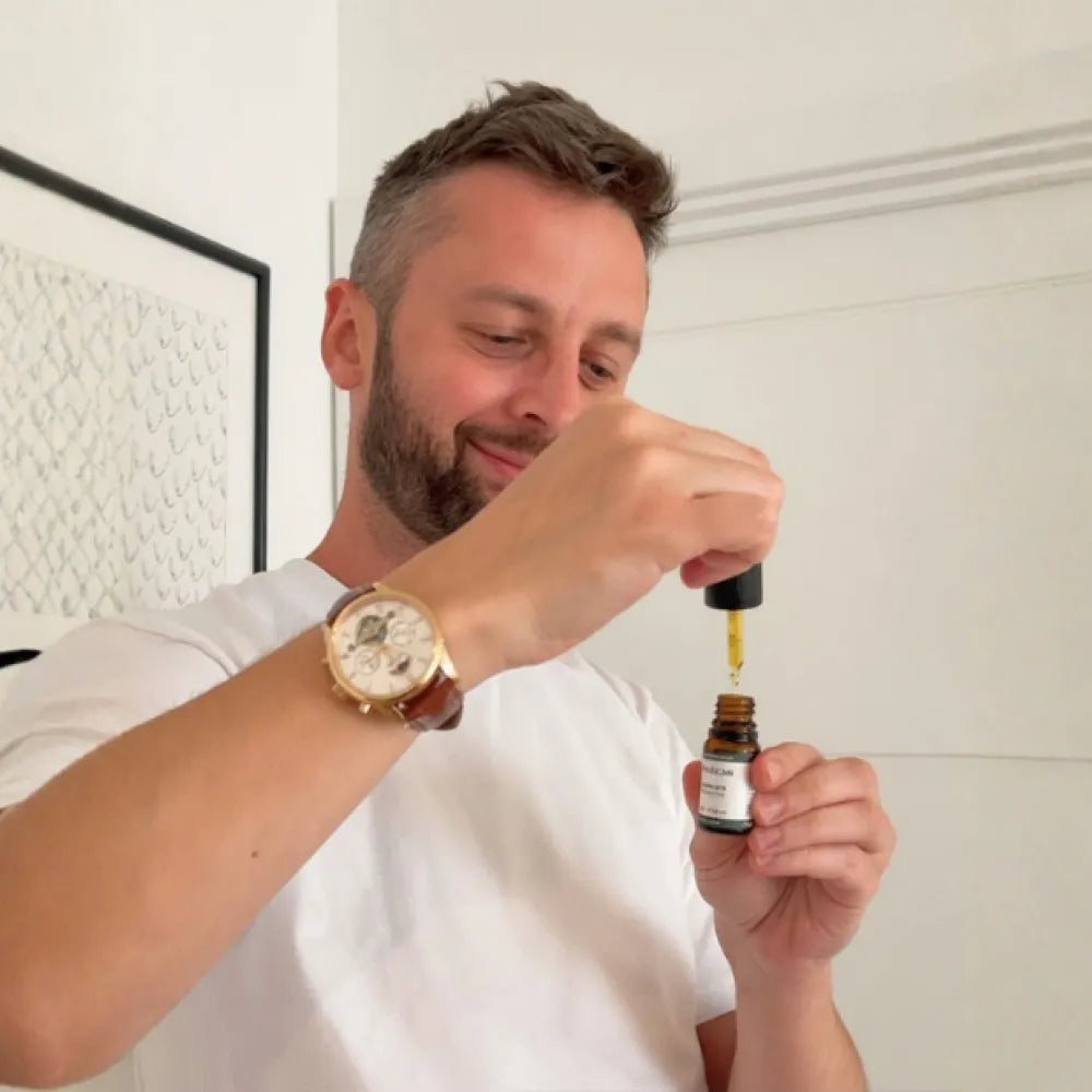 Man holding a dropper of Provacan Complete 600mg 6% CBD oil