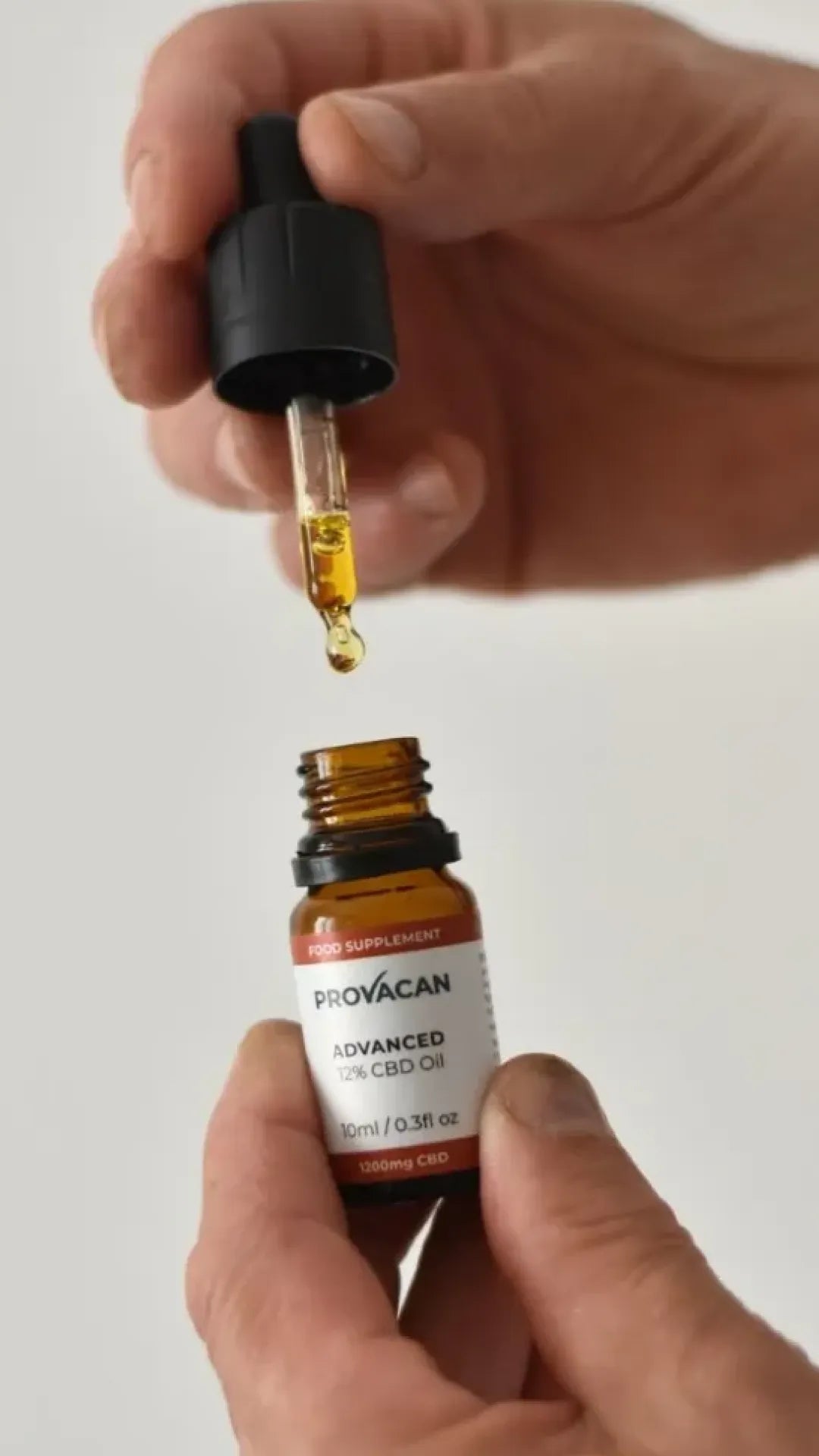 Hands holding a bottle and dropper of Provacan Advanced 12% 1200mg CBD Oil 