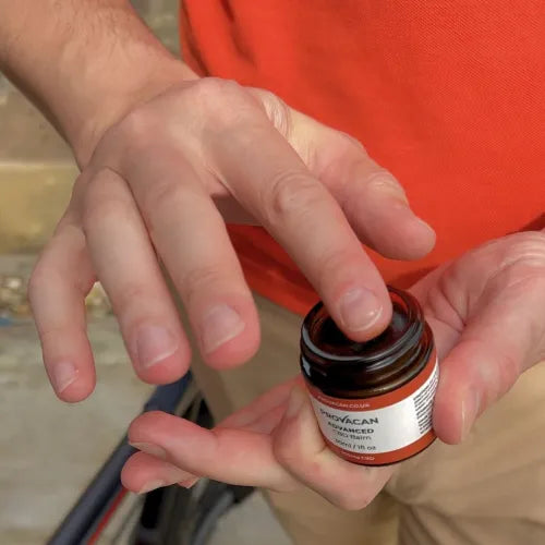 Hands holding and taking some of Provacan Advanced 900mg CBD Balm