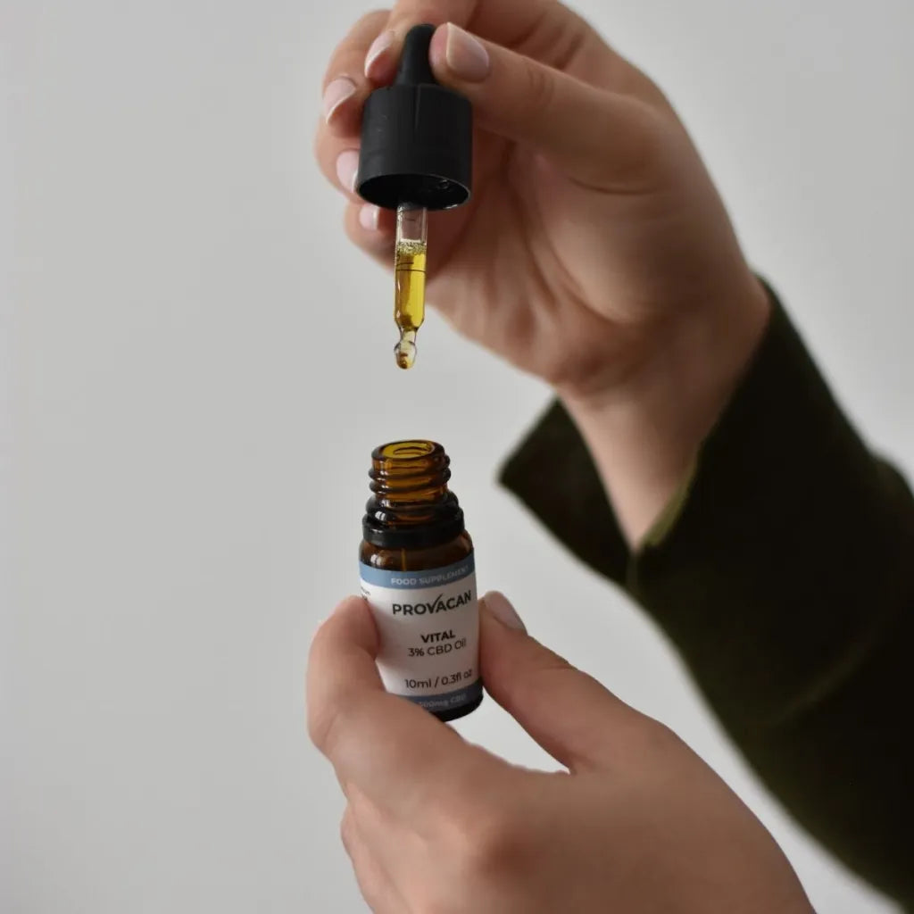 Person holding an open bottle of Provacan Vital 3% CBD Oil